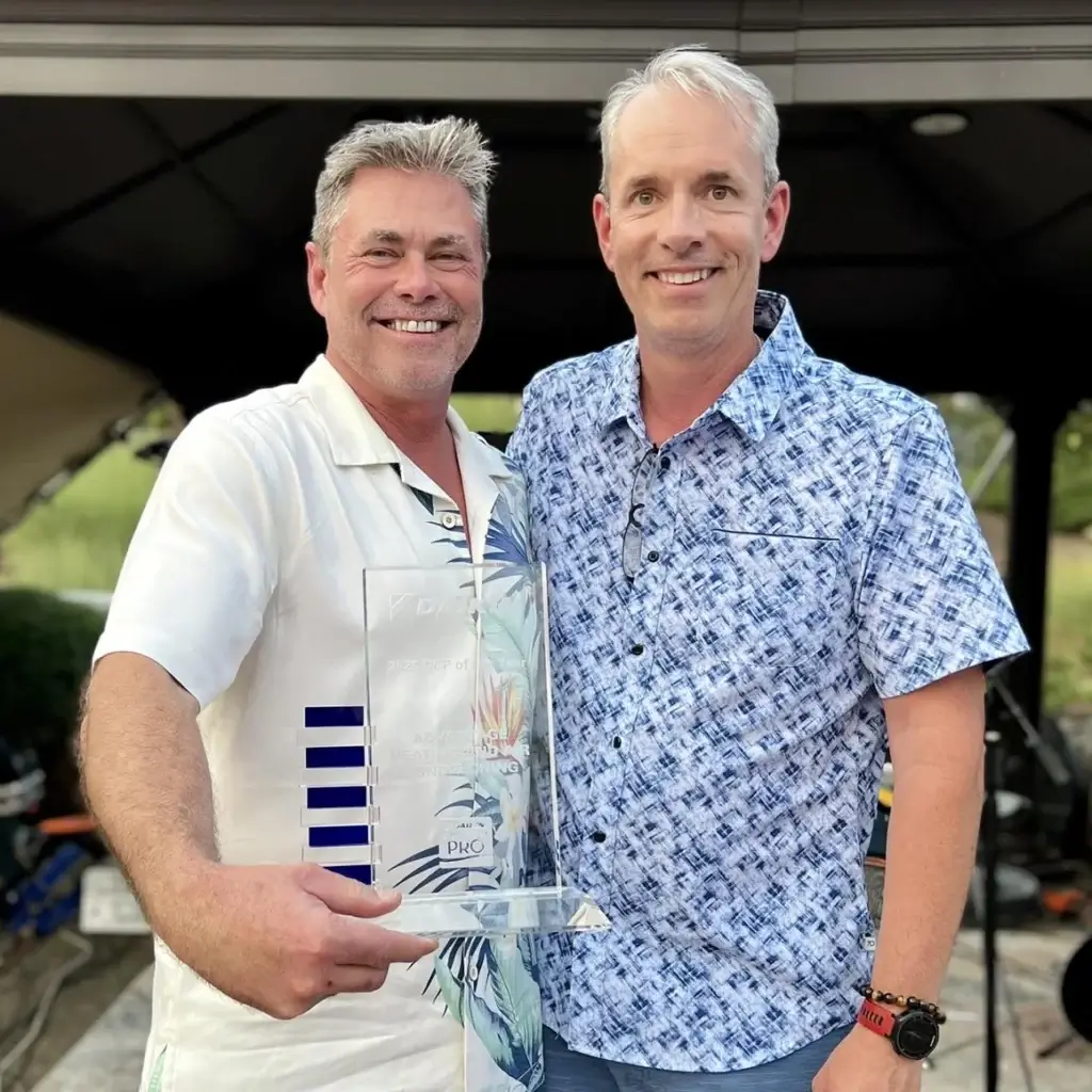 Two men holding an award