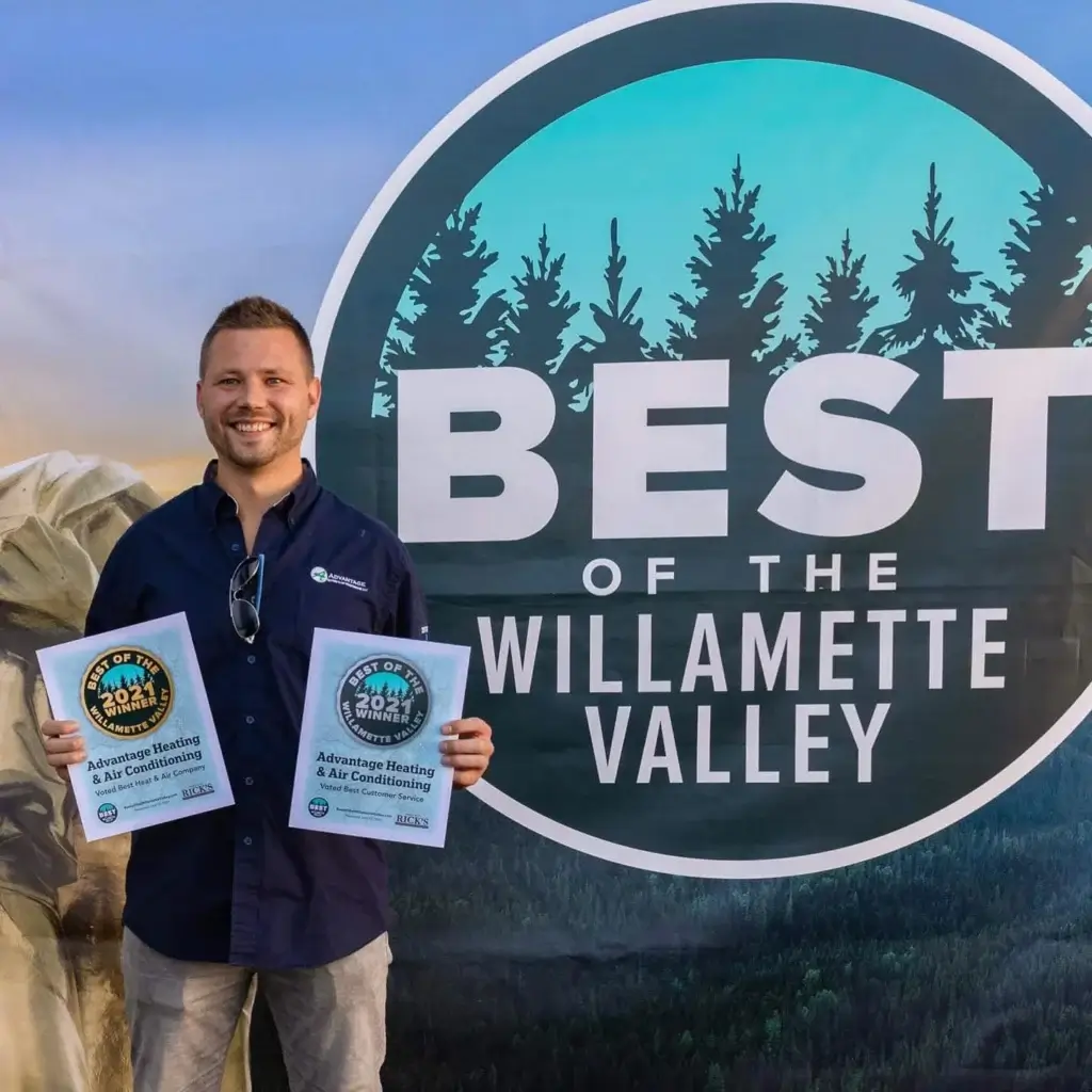 Man holding best of Willamette Valley awards for Advantage Heating and Air Conditioning