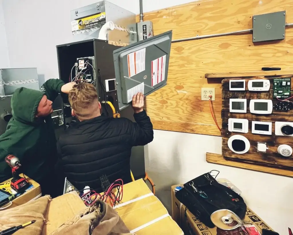 Two advantage workers inspecting HVAC unit