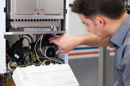 Worker inspecting a furnace
