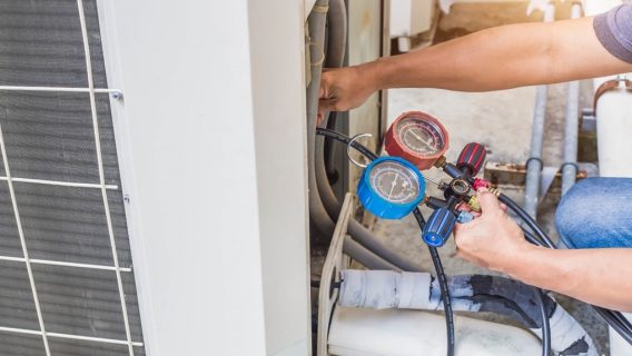 A person holding a pressure gauge